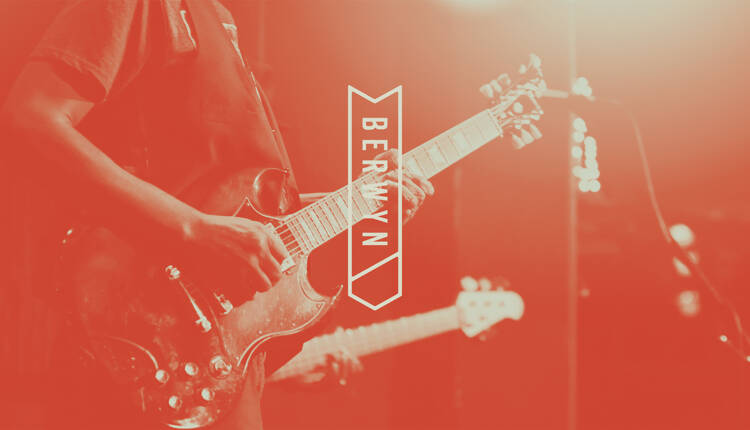Berwyn logo overlaid on image of two people playing guitars on stage