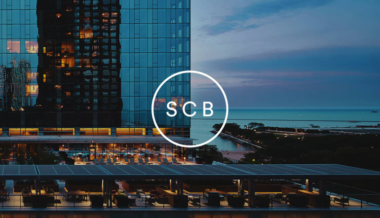 SCB logo overlaid on image image of Chicago highrise and Lake Michigan
